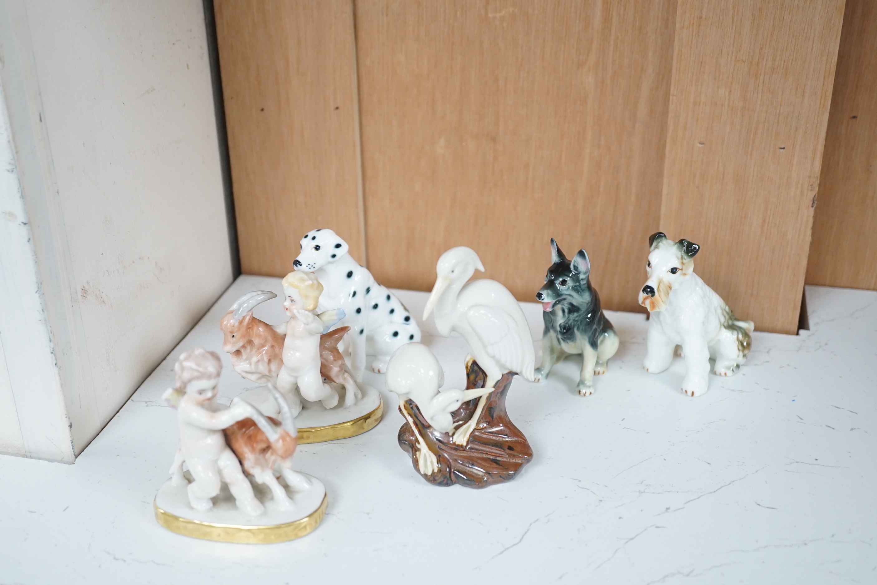 A 19th century Staffordshire zebra and mixed animals and putti ceramics, tallest putti vase 13.5cm high (14)